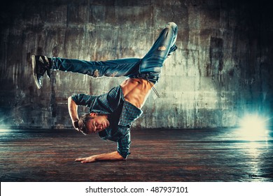 Young Man Break Dancing On Old Wall Background