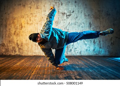 Young man break dancing on wall background. Vibrant colors effect. - Shutterstock ID 508001149