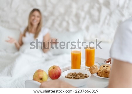 Similar – Image, Stock Photo Healthy breakfast on tray and couple lying in background