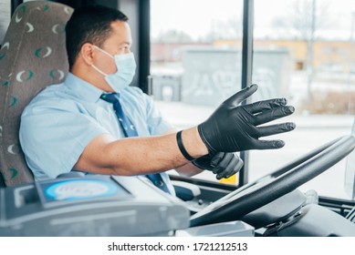 Young Man Bus Driver Has Blue Medical Protection Mask Puts Black  Gloves On His Hands To Protect Himself From The Coronavirus Epidemic, Covid 19. Protect From Corona Virus. Quarantine 2020