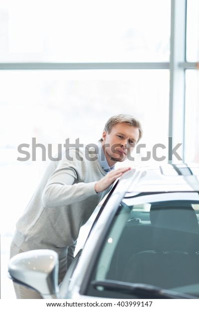 Young man buying a car\
indoors
