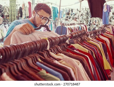 Young Man Buying In Second Hand Store