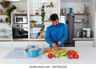 Young Man Cancer Survivor Cooking And Preparing Vegetarian Meal After Long Heavy Sickness. Vegan Male In The Kitchen Making Healthy Lunch From Fresh Vegetables Changing His Way Of Life After Illness.