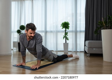 Young Man Cancer Survivor Practicing Home Workout Yoga Training, Stretching Muscles And Breathing Exercise For Healthy Life After Long Struggle With Sickness And Pain.