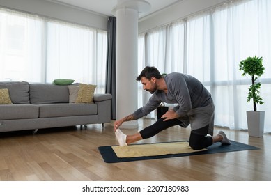 Young Man Cancer Survivor Practicing Home Workout Yoga Training, Stretching Muscles And Breathing Exercise For Healthy Life After Long Struggle With Sickness And Pain.