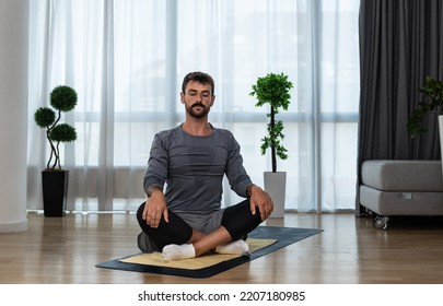 Young Man Cancer Survivor Practicing Home Workout Yoga Training, Stretching Muscles And Breathing Exercise For Healthy Life After Long Struggle With Sickness And Pain.