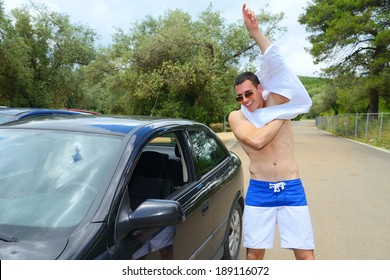 Young Man Car Driver Changing Clothes In Car