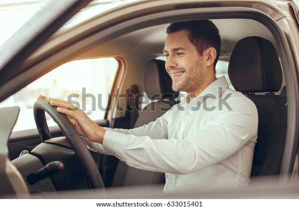 Young Man\
in a Car Rental Service Test Drive\
Concept