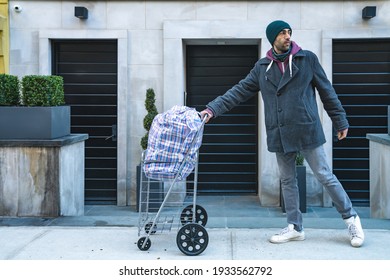 Young Man Carrying Large Bazar Bag In Cart For The Thrift Shop, Charity, Cleaning Space, Moving, Donation Concept. Wearing Face Mask. Outdoors