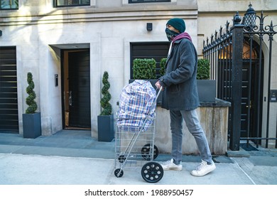 Young Man Carrying Large Bazar Bag In Cart For The Thrift Shop, Charity, Cleaning Space, Moving, Donation Concept. Wearing Face Mask. Outdoors