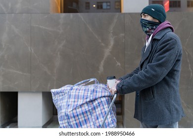 Young Man Carrying Large Bazar Bag In Cart For The Thrift Shop, Charity, Cleaning Space, Moving, Donation Concept. Wearing Face Mask. Outdoors