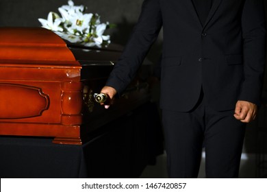 Young man carrying wooden casket in funeral home, closeup - Shutterstock ID 1467420857