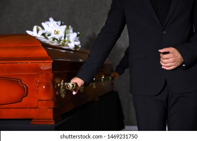 Young man carrying wooden casket in funeral home, closeup - Shutterstock ID 1469231750