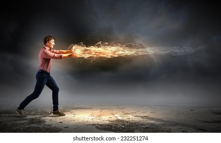 Young Man In Casual Throwing Magic Fire Balls