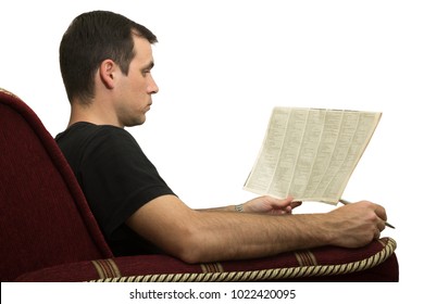 Young Man In A Chair Reading A Newspaper With An Advertisement - In Search Of Work