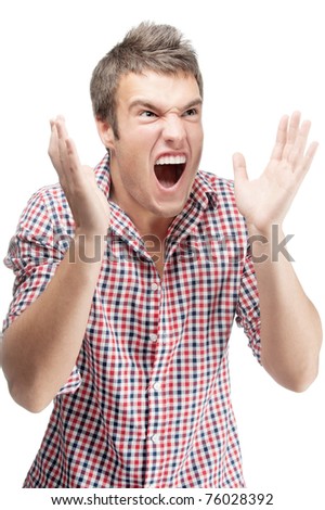 Young man in checkered shirt has opened mouth from surprise, isolated on white background.