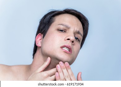 Young Man Checking His Facial Skin. Men's Skincare Concept.