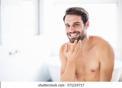 Young Man Checking His Stubble In Bathroom