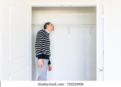 Young Man Checking Looking Inside Small Closet In New Room After Or Before Moving In, During Open House