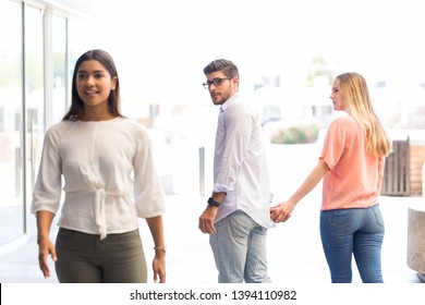 Young Man Checking Out Other Woman While Walking With Girlfriend In Shopping Center