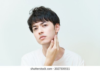 Young man checking skin condition