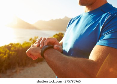 Young Man Checking Time On His Sports Watch