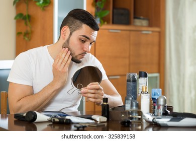 Young Man Checks In The Mirror Of Your Problem Skin