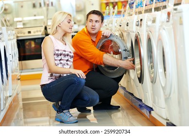 Young Man Choosing Washing Machine In Home Appliance Shopping Mall Supermarket