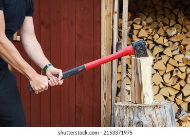 Young man chopping firewoods outdoors - Powered by Shutterstock