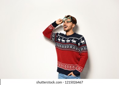 Young Man In Christmas Sweater With Party Glasses On White Background