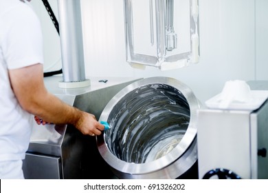 Young Man Is Cleaning Machine Of Ice Cream.