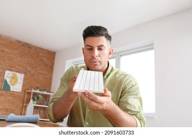 Young Man Cleaning PC Keyboard At Home