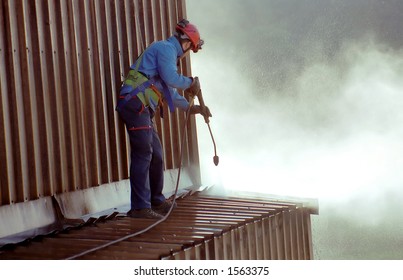 Young Man, Cleaning The Roof Of An Ironworks.