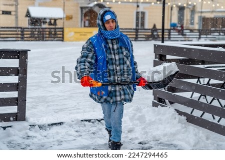 Similar – Image, Stock Photo A man clears snow from a street with a snow shovel