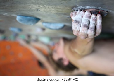 Young Man Climbing Indoor Wall