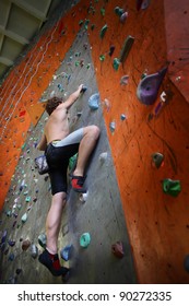 Young Man Climbing Indoor Wall