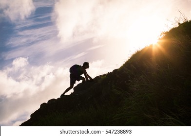 Young man climbing up a mountain. Self improvement and life goals concept.  - Shutterstock ID 547238893