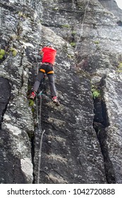 Young Man Climbing On Via Ferrata Himmelstigen, Trolltunga Way Norway