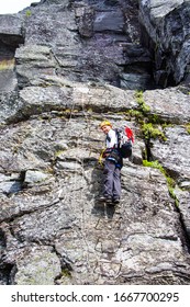 Young Man Climbing On Via Ferrata Himmelstigen, Trolltunga Way Norway