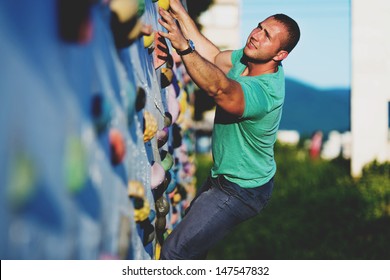 Young Man Climbing Wall Rock Outdoors