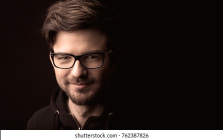 young man close up portrait, on black background - Powered by Shutterstock