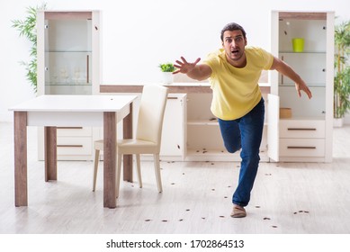 Young man and a lot of cockroaches at home - Powered by Shutterstock