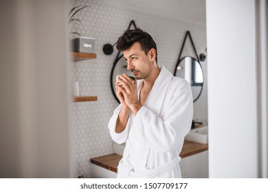 Young Man With Coffee In The Bathroom In The Morning.