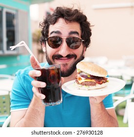 young man with coke and a burger