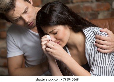 Young man comforting crying sad woman, caring friend consoling upset girl in tears, loving husband helping wife overcome problems or grief, compassion, empathy and support in relationships concept - Powered by Shutterstock