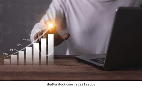 Young man with computer notebook hand touching to visualize money growth The phone screen displays graphs and charts showing increasing investment and savings trends, increased account
