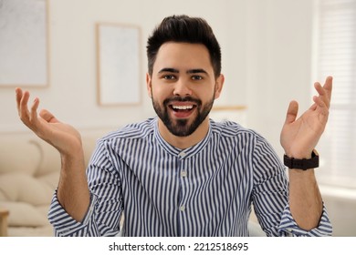 Young Man Conducting Webinar In Room At Home