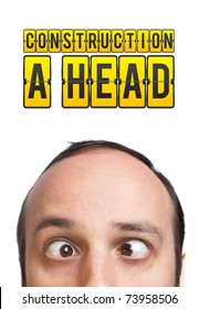 Young man with "CONSTRUCTION A HEAD" mark over his head, isolated on white