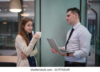 Young Man Consulting His Business Partner At Meeting In Office