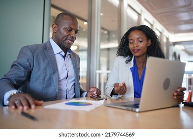 Young Man Consulting His Business Partner At Meeting In Office